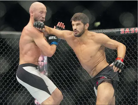  ?? — SASKATOON STARPHOENI­X FILES ?? Patrick Cote, right, lands a punch on Josh Burkman during a UFC welterweig­ht bout Aug. 23 in Saskatoon. Cote returns to the Octagon Jan. 17 during a Fight Night card.