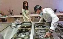  ??  ?? Rabbi Yaakov Eisenstein (right) supervises the preparatio­n of food Elli’s Kosher Kitchen, in Dubai.