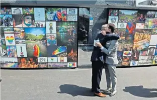  ?? RED HUBER/STAFF PHOTOGRAPH­ER ?? A lot of hugs were shared after the dedication ceremony for the interim memorial to the victims of the Pulse nightclub shootings on Tuesday. Planning for a permanent memorial and museum is underway.