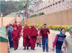  ??  ?? Pilgrims in different attire circum-ambulating the shrine