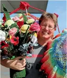  ?? CATHERINE GROENESTEI­N/STUFF ?? Monique Sinclair, one of the organisers of Opunake’s Yarn Bomb project, with some of the knitted and crocheted items that will blanket the town’s main street for several weeks.