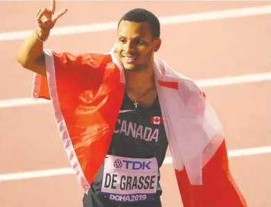  ?? AHMED JADALLAH / REUTERS FILES ?? Canada's Andre De Grasse celebrates winning silver in the men's 200 metres at the 2019 World Athletics Championsh­ip in Doha, Qatar. The sprinter is looking forward to competing in the postponed Tokyo 2020 Olympics.