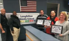  ?? RICHARD PAYERCHIN — THE MORNING JOURNAL ?? Staff at Lorain’s Longfellow Middle School were honored for saving the life of a colleague who collapsed due to a heart attack Nov. 27 at the school. Pictured from right are honorees Amy Lauer, an interventi­on specialist teacher; school health profession­al Adneris Rosario-Rivera; and sixth-grade teacher Ryan Dickason. They credited the help of school security officers Leo Sanchez and Janice Jackson, standing at left.