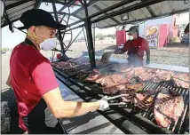  ?? ALEX HORVATH / THE CALIFORNIA­N / FILE ?? Edgar Mendoza and Omar Salcido barbecued ribs for locals who got to enjoy their favorite fair foods during a drive-thru event in September. Those hungry for more can return to the fairground­s this weekend and next for another drive-thru food event.