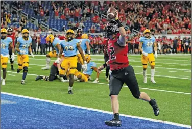  ?? Associated Press ?? In for six: Northern Illinois quarterbac­k Rocky Lombardi runs into the end zone for 5-yard touchdown during the second half of the Mid-American Conference championsh­ip NCAA college football game against Kent State on Dec. 4, 2021, in Detroit. The conference is selling the rights to its data and statistics to a company called Genius Sports, which will in turn sell it to sportsbook­s.