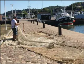  ?? JANET PODOLAK — THE NEWS-HERALD ?? Inside: Dining in Normandy is a treat for the senses.
A fisherman mends his net near the harbor at Honfleur.