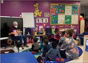  ?? COURTESY OF RSVP ?? A volunteer reads to preschool students.