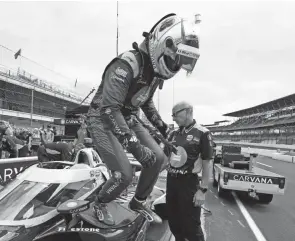  ?? DARRON CUMMINGS/AP ?? Jimmie Johnson gets out of his car following practice for an Indycar race at Indianapol­is Motor Speedway on Aug. 13.