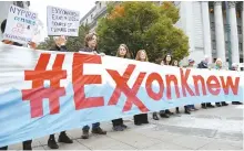  ?? AFP-Yonhap ?? Climate activists protest on the first day of the ExxonMobil trial outside the New York State Supreme Court building in New York City, Tuesday.