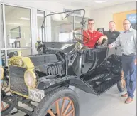  ?? TY DUNHAM PHOTO ?? D. Alex MacDonald Ltd. sales staff Pat Ramsay, left, Billy Williams and Craig MacLaren, right, pose with the 1915 Model-T Ford sitting in the showroom, showing customers just how far Ford has come in terms of safety, performanc­e, and technology.