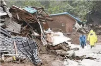  ?? YUN KWAN-SHICK YONHAP VIA AP ?? Houses collapsed from a landslide caused by heavy rain are seen in Yecheon, South Korea, Saturday.