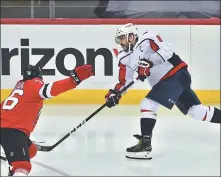  ?? USA TODAY SPORTS ?? Washington Capitals left wing Alex Ovechkin shoots the puck against the New Jersey Devils during the second period at Prudential Center in Newark on Sunday. Ovechkin moved into a secondplac­e tie on the all-time list for NHL power-play goals and the Capitals beat the Devils 5-4.