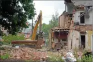  ??  ?? Crews from Geppert Brothers demolish the Keenan home in Perkase Sept. 4.