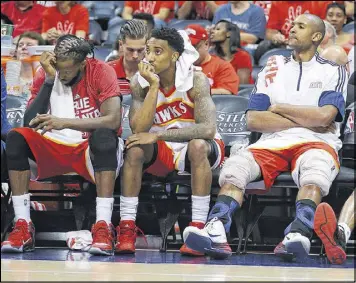  ?? CURTIS COMPTON / CCOMPTON@AJC.COM ?? The looks tell the tale as DeMarre Carroll (from left), Jeff Teague and Al Horford watch the final minutes tick away in Atlanta’s Game 2 defeat.