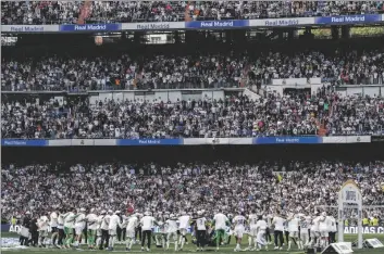  ?? AP PHOTO/BERNAT ARMANGUE ?? Real Madrid celebrate La Liga title after a Spanish La Liga soccer match between Real Madrid and Espanyol at the Santiago Bernabeu stadium in Madrid, in Saturday.