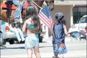  ?? ?? From the files, 2005: Angelina (left) and Auggie Godinez watch as mounted riders parade down East Road in Redwood Valley during the Black Bart Parade.