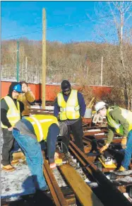  ?? Contribute­d photo / ?? Gateway Community College students Avery Blank, Jeff Hackner, Shannon Denny, Kunga Chodek and Keith DeCosta apply their skills on a stretch of railroad in an undated photo.