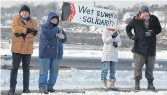  ??  ?? There were many signs at a rally in Annapolis Royal in support of Wet’suwet’en Hereditary Chiefs in northern British Columbia who oppose a gas pipeline being built by Coastal GasLink through their ancestral territorie­s.