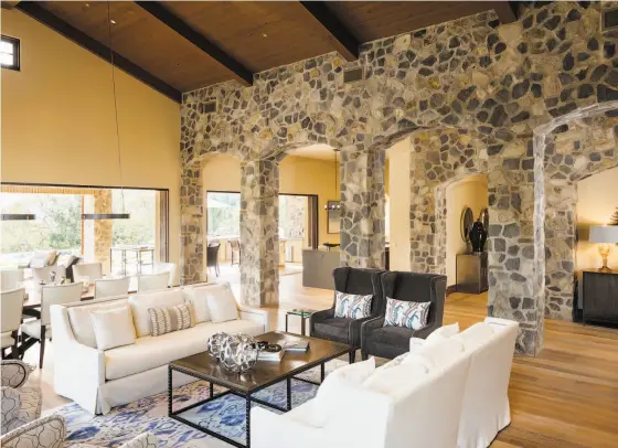  ?? Jacob Elliott Photograph­y ?? Stone arches and wood-paneled ceilings lend a rustic, European aesthetic to the living room of 730 Adobe Canyon Road.