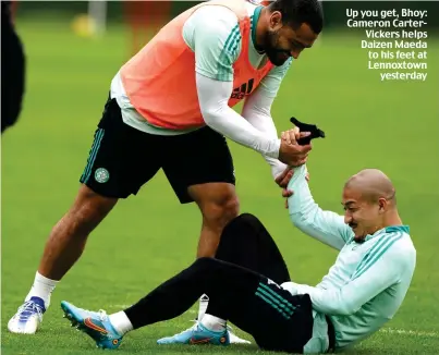  ?? ?? Up you get, Bhoy: Cameron CarterVick­ers helps Daizen Maeda to his feet at Lennoxtown yesterday