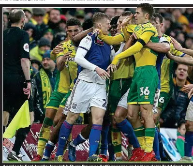  ??  ?? Angrier in East Anglia: Ipswich’s Flynn Downes (left) squares up to Norwich’s Todd Cantwell as team-mates pile in