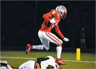  ??  ?? Baylor’s Elijah Howard hurdles over a Knoxville Catholic defender during the first half Friday.