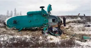  ?? — AFP ?? A handout picture released by Russia’s Emergencie­s Ministry shows Russian rescuers working at the site where a Mi-8 helicopter crashed overnight outside the city of Novy Urengoy.