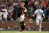  ?? RAY CHAVEZ — BAY AREA NEWS GROUP ?? The Dodgers’ Justin Turner (10) scores past Giants catcher Buster Posey (28) on an RBI single by Cody Bellinger in the ninth inning of Game 5 of the National League Divisional Series at Oracle Park in San Francisco on Thursday.