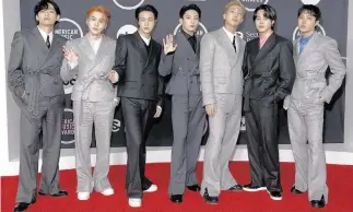  ?? AMY SUSSMAN Getty Images/TNS, file ?? From left, V, Suga, Jin, Jungkook, RM, Jimin and J-Hope of BTS attend the 2021 American Music Awards.