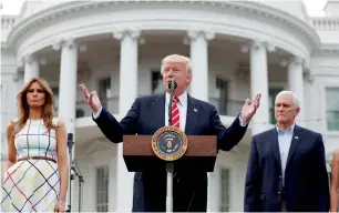  ?? AP ?? Donald Trump speaks as first lady Melania Trump and Vice-President Mike Pence look on the South Lawn of the White House. —