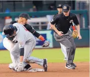  ?? JIM THOMPSON/JOURNAL ?? Umpire Clay Park watches as the Isotopes’ Cristhian Adames, rear, makes the tag on El Paso’s Nick Buss, who was out on a stolen base attempt Wednesday night.