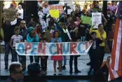  ?? NHAT V. MEYER – STAFF PHOTOGRAPH­ER ?? Supporters of Calvary Chapel San Jose wave to cars outside of Santa Clara Superior Court in downtown San Jose on Tuesday.