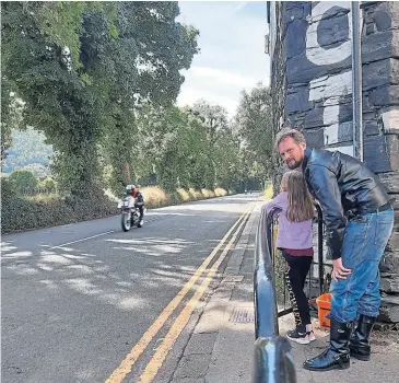  ?? ?? Dave’s granddaugh­ter Alice gets her first taste of Isle of Man racing, overseen by dad John..