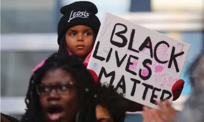  ??  ?? Attendees at a Black Lives Matter rally at Toronto police headquarte­rs on 26 March. Photograph: Steve Russell/Toronto Star via Getty Images