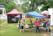  ?? Janelle Jessen/Herald-Leader ?? Mary Fears, Chamber of Commerce director of operations, helped Dogwood Festival vendors move their tents away from Sager Creek on Saturday afternoon after several hours of heavy rain flooded Sager Creek. About 80 vendors persisted through the storms...