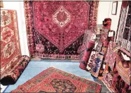  ?? Arnold Gold / Hearst Connecticu­t Media ?? Left, a vintage fur coat at The Trove antique store. Right, vintage handmade rugs at a booth at The Trove on the Boston Post Road in Old Saybrook.