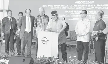  ??  ?? Photo shows Sultan Ibrahim Sultan Iskandar signing a plaque to officiate the launch of Forest City real estate developmen­t with Najib (fourth left) and Menteri Besar Johor, Datuk Seri Mohamed Khaled Nordin (third left) looking on. The federal...