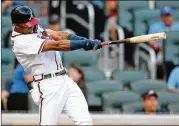  ?? CURTIS COMPTON / CCOMPTON@AJC.COM ?? Rookie RonaldAcun­a connects for his third leadoffhom­er in a rowto give the Braves a quick lead over the Marlins on Tuesday night.