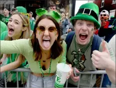  ?? PHOTO BY JIM MICHAUD — BOSTON HERALD ?? BOSTON, MA MARCH 20: People enjoying the festivitie­s during the St Patrick’s Day parade as thousands turned out on a beautiful day to see the return of the parade after the cancellati­ons of the past two years because of the pandemic, Sunday, March 20, on West Broadway in Boston. Sunday March 20, 2022, in South Boston.