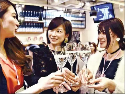  ?? THE JAPAN NEWS ?? Women enjoy a glass of sparkling sake. The popularity of smooth, sweet sparkling sake is bubbling over in Japan.