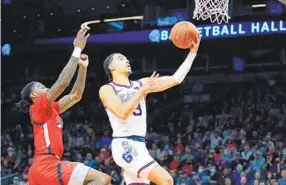  ?? ROSS D. FRANKLIN AP ?? Gonzaga guard Andrew Nembhard (right) goes up for two of his 16 points in front of Texas Tech guard Davion Warren during the first half of the Jerry Colangelo Classic.