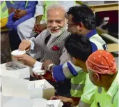  ?? — PTI ?? Prime Minister Narendra Modi talks with Indian workers working in Doha at a camp on Saturday.