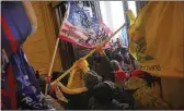  ??  ?? Trump supporters breaking into the U.S. Capitol