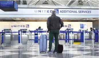  ?? SCOTT OLSON/GETTY IMAGES ?? There was plenty of elbow room for this United Airlines passenger arriving for a flight at O’Hare Airport. Like other airlines, United has taken a big hit with people traveling less because of the pandemic.