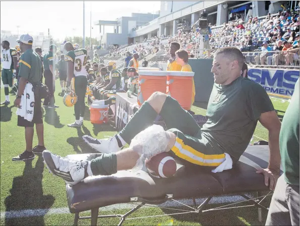  ?? — THE CANADIAN PRESS FILES ?? Edmonton Eskimos quarterbac­k Mike Reilly ices his knee after being injured during second half CFL football action against the Toronto Argonauts Saturday. Later in the day, Saskatchew­an Roughrider­s lost pivot Darian Durant to injury for the season.