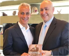  ?? (Courtesy) ?? CHICAGO MAYOR Rahm Emanuel and Chemi Peres, chairman of the Peres Center for Peace and Innovation, display a copy of the autobiogra­phy of Shimon Peres.