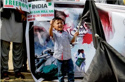  ?? AP ?? A boy chants slogans during a demonstrat­ion called by a civil society group to mark Jammu Martyrs Day in Islamabad on Sunday. Protesters gathered to express solidarity with Kashmiris who are resisting Indian rule. —