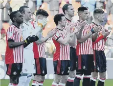  ??  ?? Sunderland players take part in the minute’s applause.