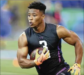  ?? AP ?? Penn State RB Saquon Barkley stole the show Friday, running a blistering 4.41 seconds in the 40 to go along with 29 reps on the bench press and a 41-inch vertical leap.