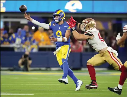  ?? KEITH BIRMINGHAM — PASADENA STAR-NEWS ?? The Rams' Matthew Stafford, left, passes the ball away from pressure from 49ers defensive end Nick Bosa during the second half of the NFC championsh­ip game at SoFi Stadium in Inglewood on Jan. 30.